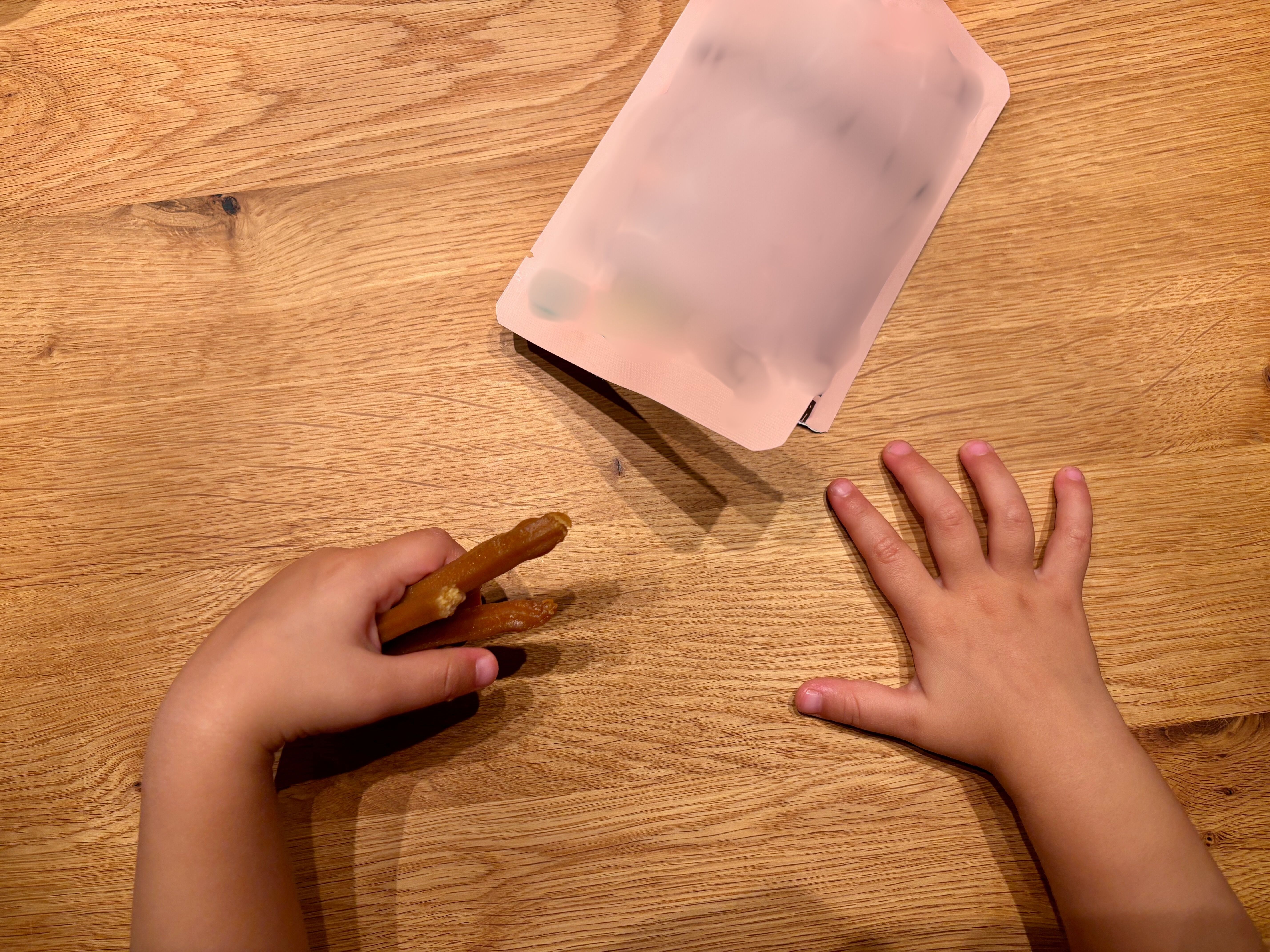 Toddler eating a sweet potato stick